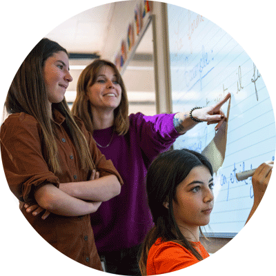 Middle school students working on the whiteboard