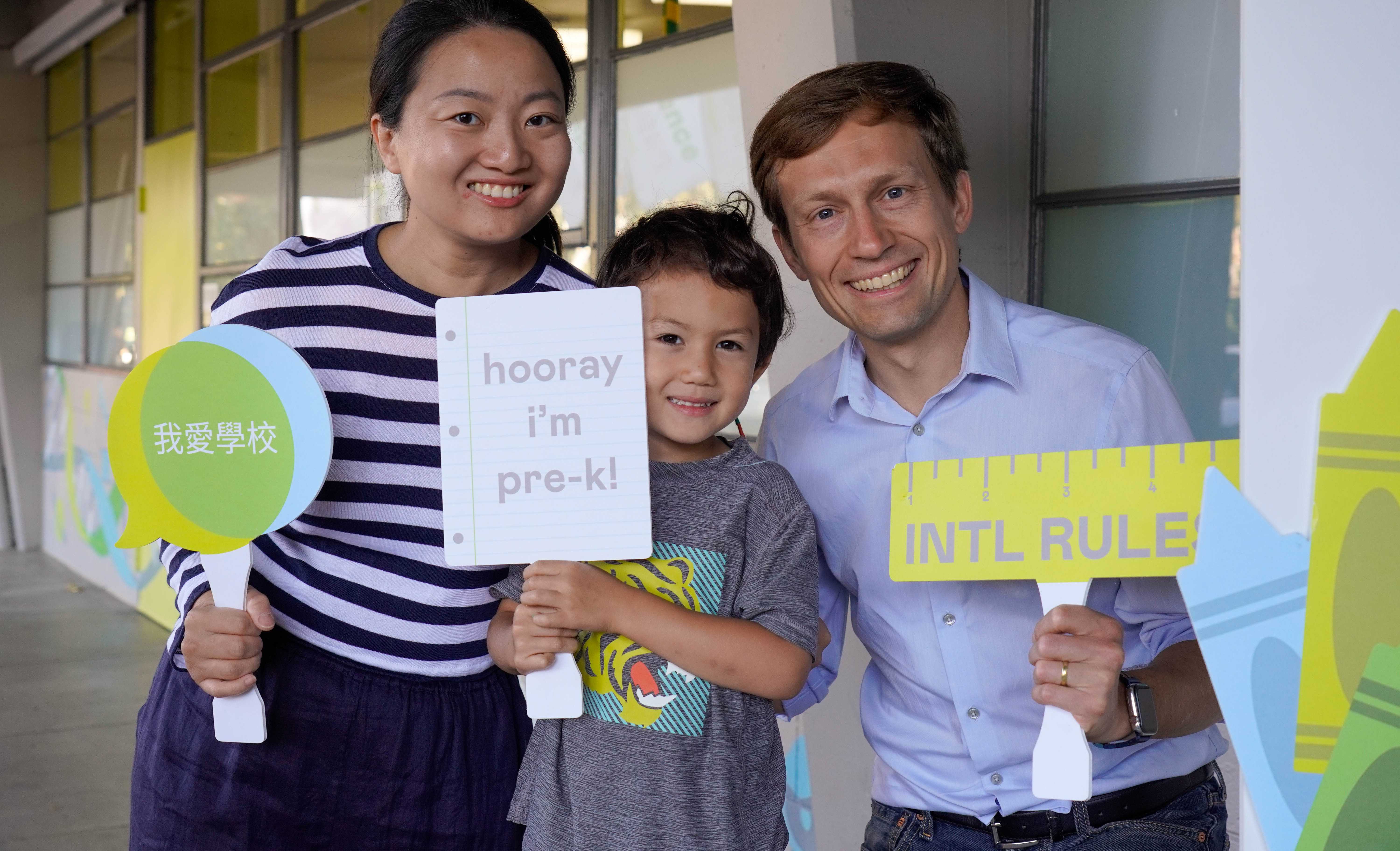 A family poses with their pre-k student on the first day of school