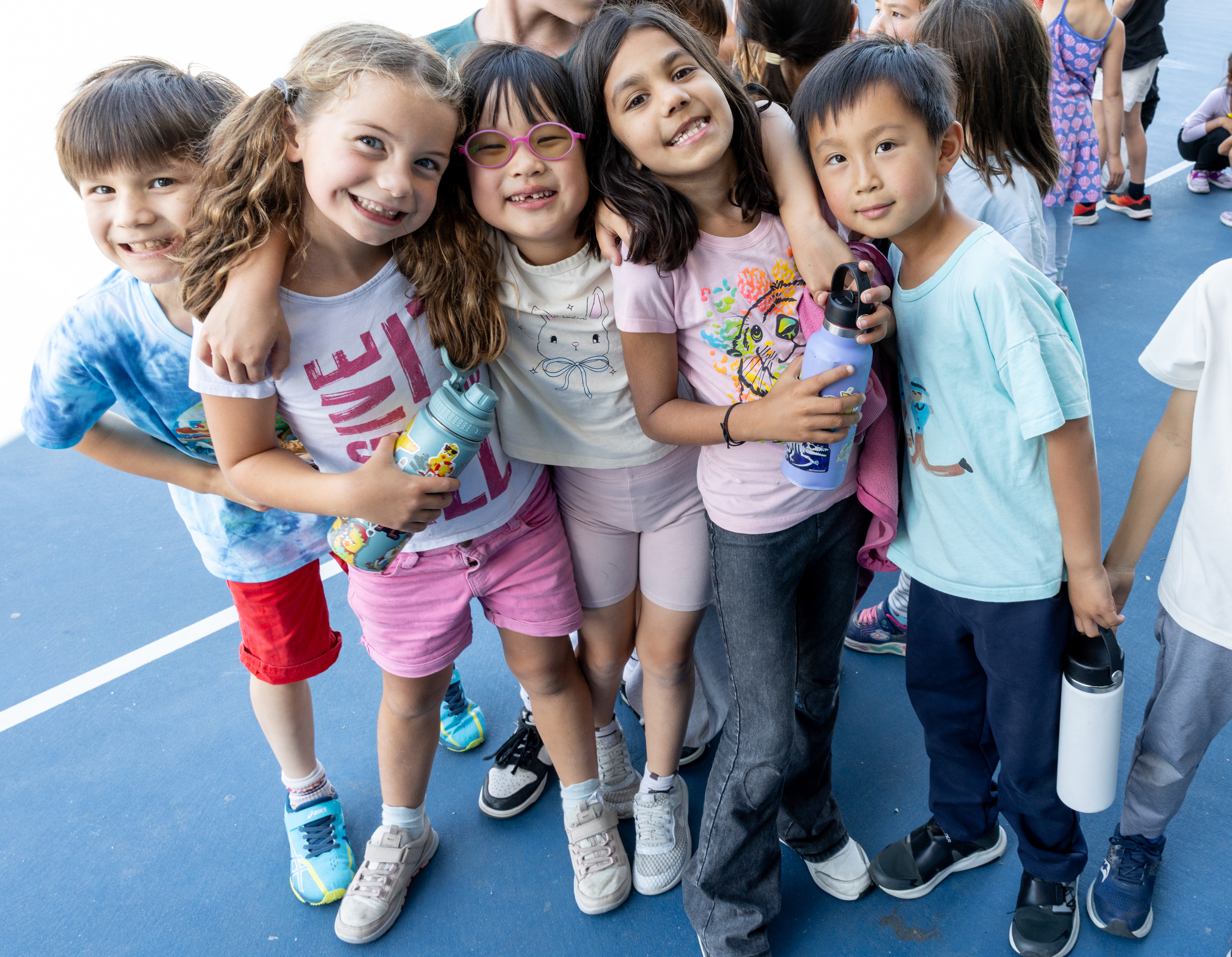 Five elementary students pose together for a photo