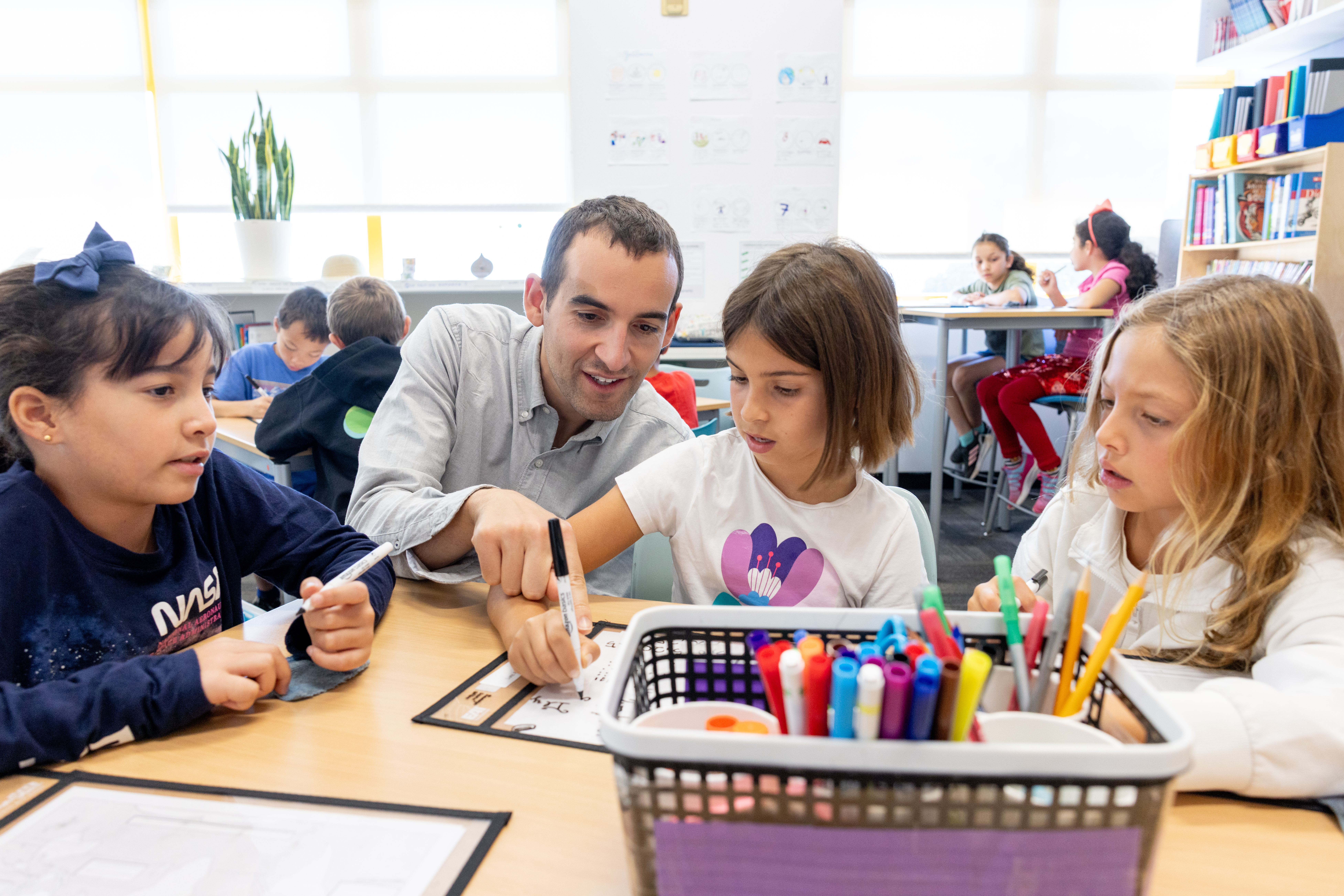 French teacher and his student working at a desk