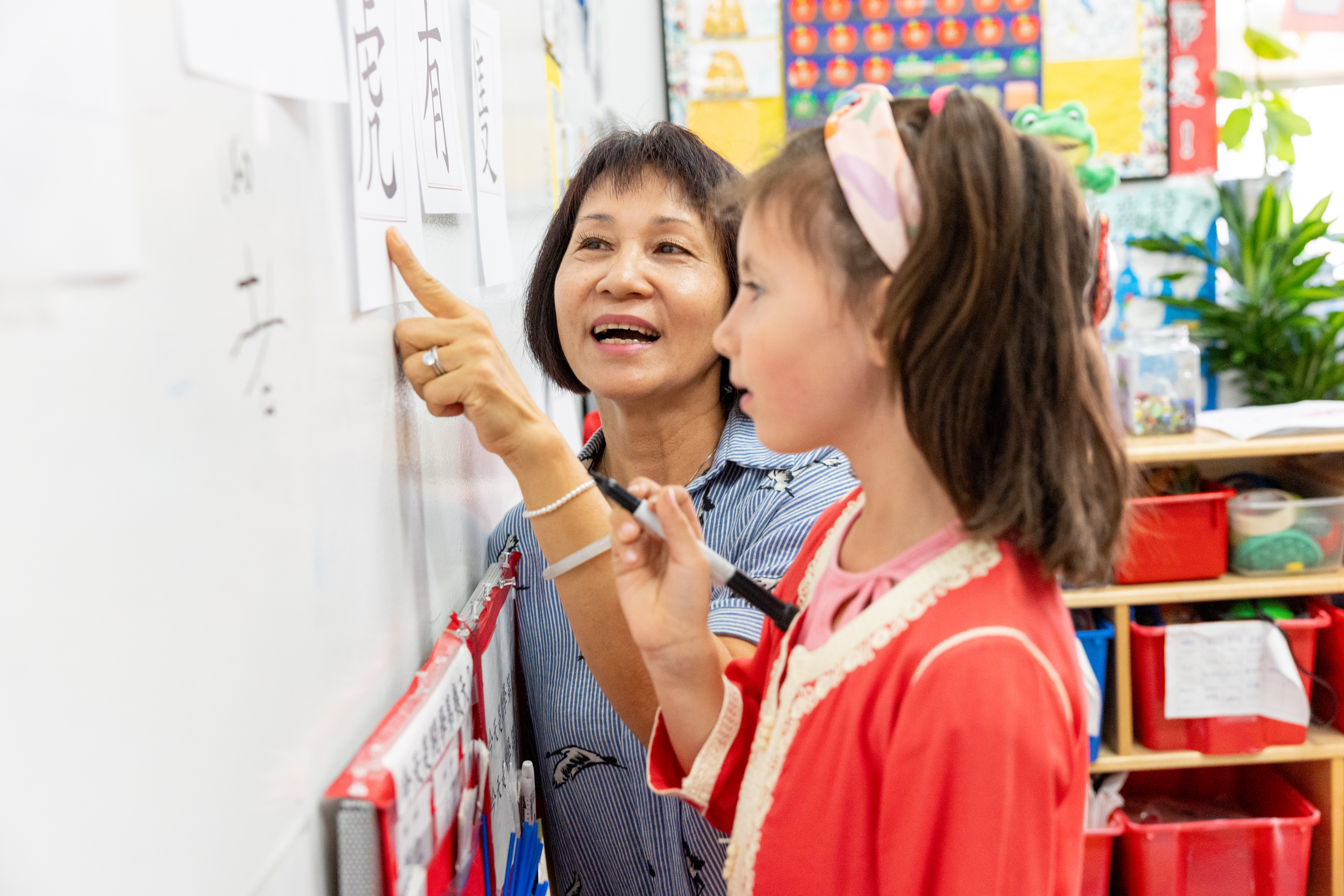 Chinese teacher and her student at the white board